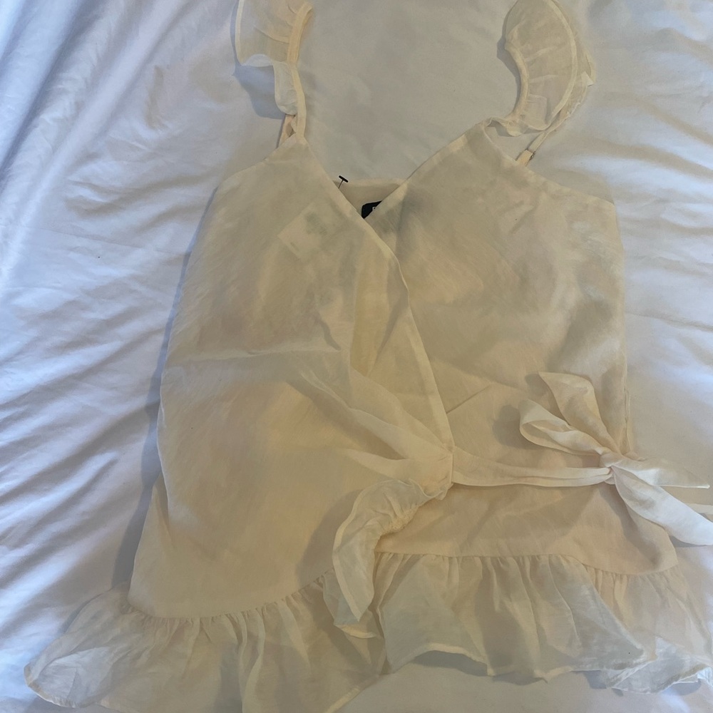 Express white see thru blouse with ruffles at the bottom and straps